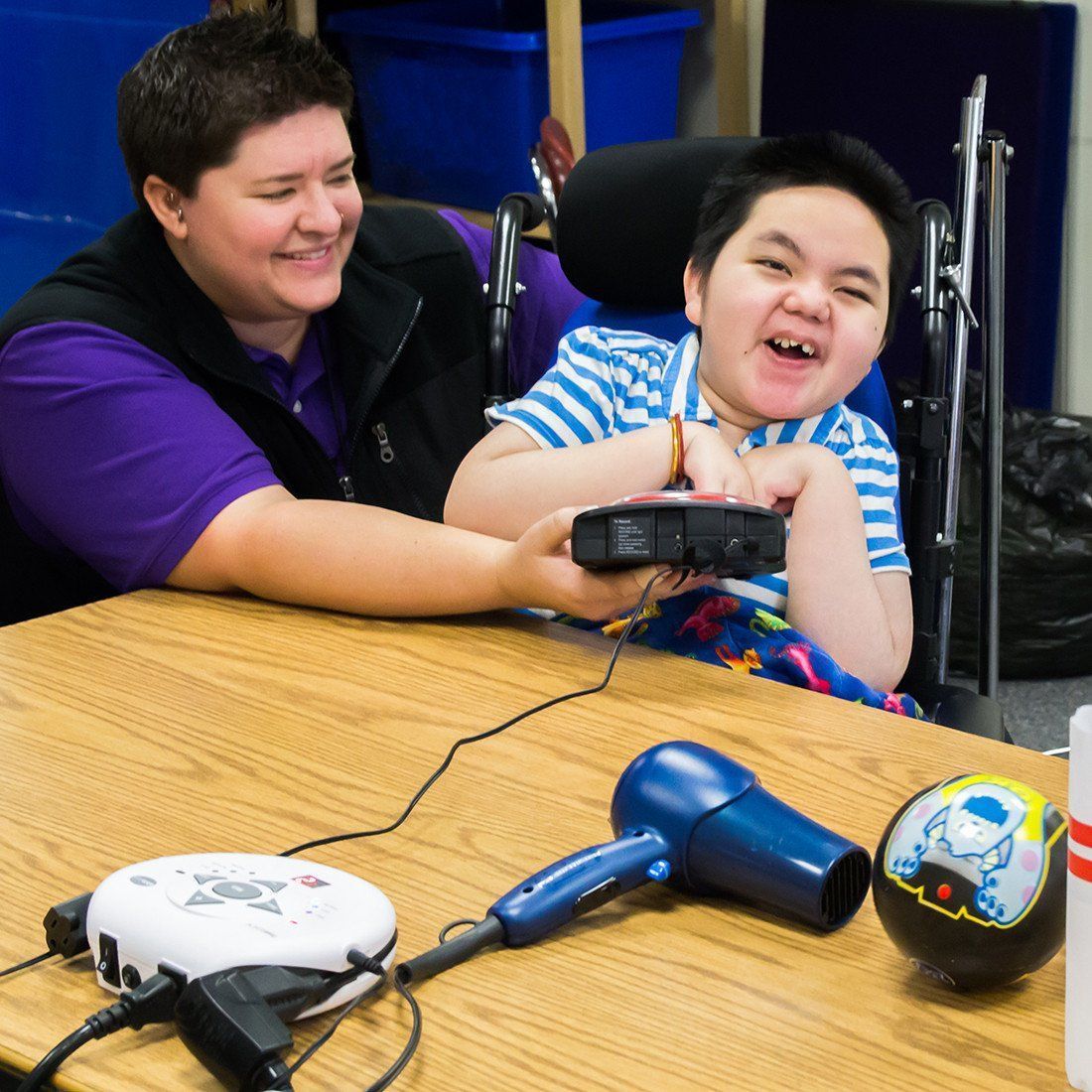 boy with powerlink and adapted fan and big mack for accessible play